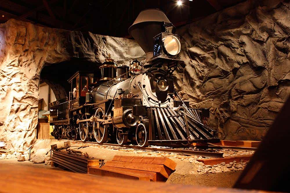 Vintage steam train inside a themed museum exhibit.